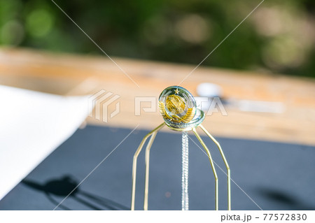 Pocket watch sovietic design shoot outside in a summer day closeup. Selective Focus 77572830
