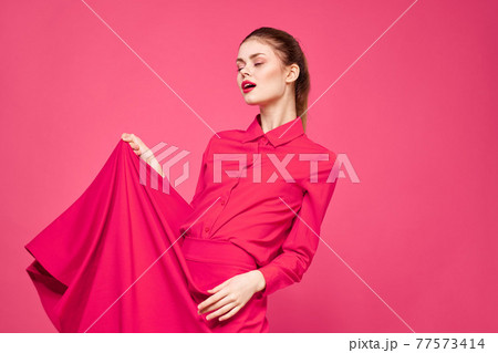 Woman on a pink background in fashionable clothes and bright makeup hairstyle model Copy Space Woman on a pink background in fashionable clothes and bright makeup hairstyle model Copy Space 77573414