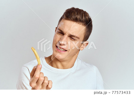 emotional man holding fries calories fast food light background white t-shirt cropped view emotional man holding fries calories fast food light background white t-shirt cropped view 77573433