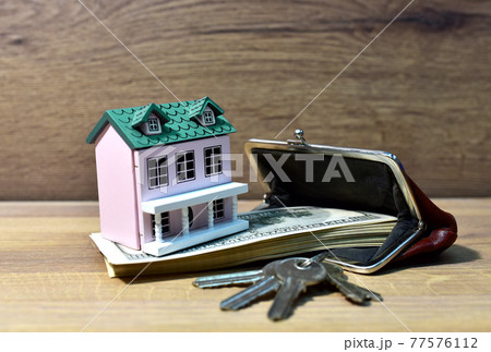 House and purse with american dollars. Home buying or selling. House and purse with american dollars. Home buying or selling. 77576112