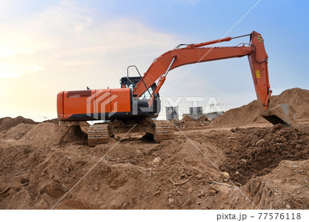 Excavator on earthworks at construction site. Excavator on earthworks at construction site. 77576118