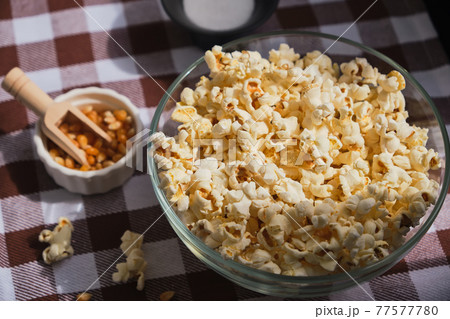 Close up delicious fresh buttery popcorn in a bowl Close up delicious fresh buttery popcorn in a bowl 77577780