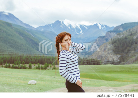 beautiful girl posing on the background of mountains 77578441