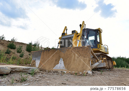 Dozer working at construction site. Bulldozer for land clearing 77578656