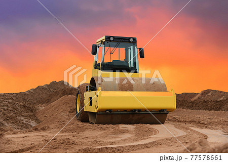 Vibration single-cylinder road roller on amazing sunset background.  77578661