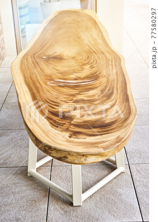 Dining table of live edge suar wood slab on metal carcass in yard Dining table of live edge suar wood slab on metal carcass in yard 77580297