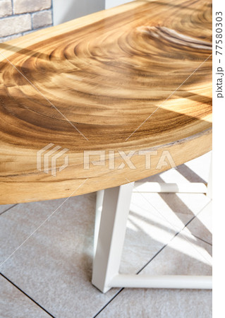 Dining table of live edge suar wood slab on metal carcass in yard Dining table of live edge suar wood slab on metal carcass in yard 77580303