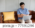 asian senior man using computer laptop at home 77591296