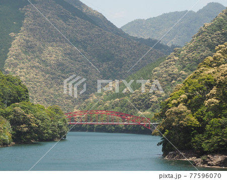 ダム湖の赤い橋 77596070