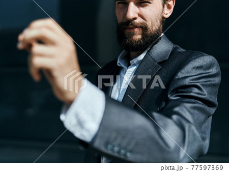 Business man in suit gestures with hand emotions outdoors lifestyle 77597369