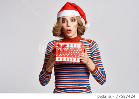 happy woman with christmas gifts in hands and red hat on head new year holidays cropped view happy woman with christmas gifts in hands and red hat on head new year holidays cropped view 77597424