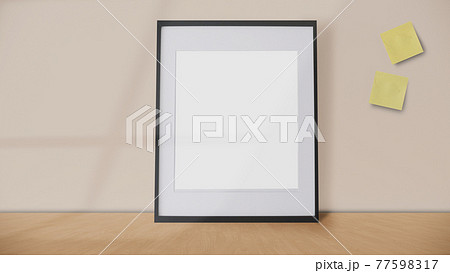 blank frame and yellow postit on a vintage wall background with window shadow. 77598317