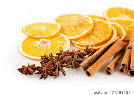 Dried oranges and spices on a white background 77598584