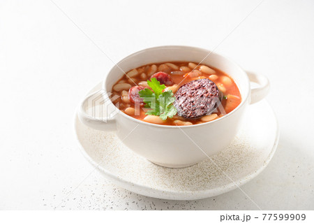 Spanish fabada on white table. Close up. Spanish fabada on white table. Close up. 77599909