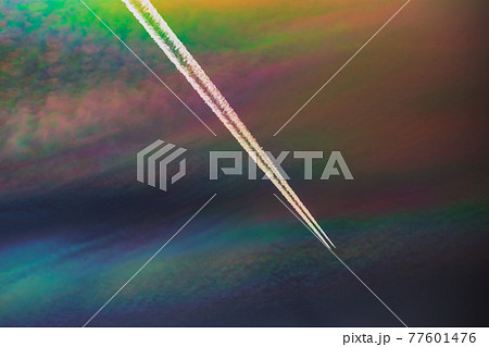 A rare sight: iridescent clouds with a plane. Diffraction can make clouds shine with colours like a corona. A rare sight: iridescent clouds with a plane. Diffraction can make clouds shine with colours like a corona. 77601476