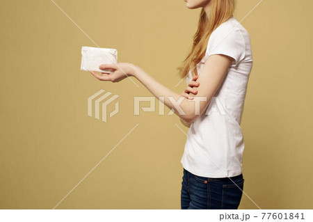 Woman with pad in hand on beige background cropped side view Woman with pad in hand on beige background cropped side view 77601841