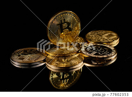 Closeup golden coin with bitcoin logo. Leader in cryptocurrency Bitcoin BTC on a top of coins against black mirror surface. A heap of decentralized digital currency. Crypto payment. Electronic money. Closeup golden coin with bitcoin logo. Leader in cryptocurrency Bitcoin BTC on a top of coins against black mirror surface. A heap of decentralized digital currency. Crypto payment. Electronic money. 77602353