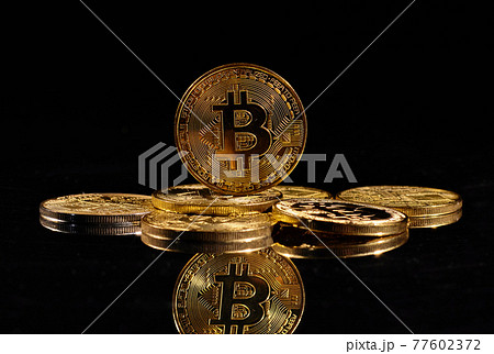 Closeup golden coin with bitcoin logo. Leader in cryptocurrency Bitcoin BTC on a top of coins against black mirror surface. A heap of decentralized digital currency. Crypto payment. Electronic money. Closeup golden coin with bitcoin logo. Leader in cryptocurrency Bitcoin BTC on a top of coins against black mirror surface. A heap of decentralized digital currency. Crypto payment. Electronic money. 77602372