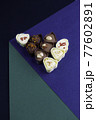 chocolate assortment candies isolated on geometric box 77602891