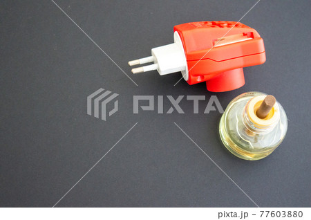 Disassembled electric mosquito repellent red on a gray background. Protection from mosquitoes at home. Copy space, isolated Disassembled electric mosquito repellent red on a gray background. Protection from mosquitoes at home. Copy space, isolated 77603880