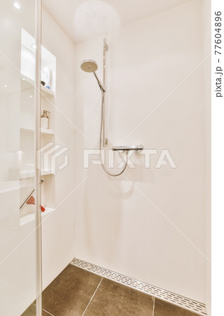Shower tap in tiled bathroom Shower tap in tiled bathroom 77604896