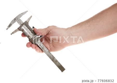 Hand holds an old caliper on a cord on a white background Hand holds an old caliper on a cord on a white background 77606832
