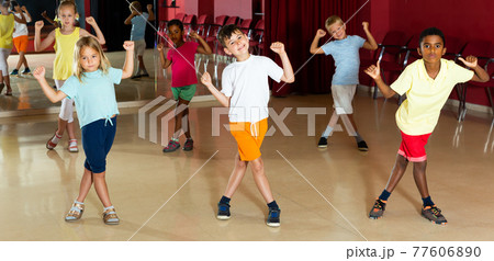 Happy kids trying balance movements of ballet Happy kids trying balance movements of ballet 77606890