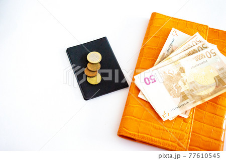 Money - 50 euros next to the orange wallet. Cash currency in euros. Wallet for credit cart Money - 50 euros next to the orange wallet. Cash currency in euros. Wallet for credit cart 77610545