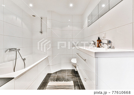 Interior of bathroom with tiled walls 77610668
