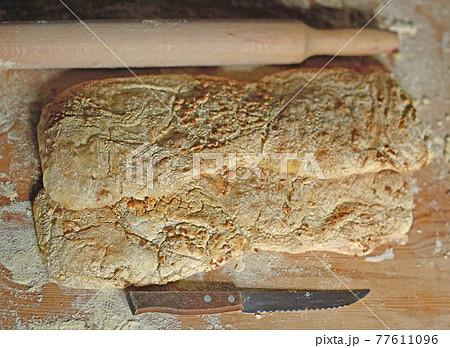 two ciabatta bread loaf fresh bake close up photo on kitchen board two ciabatta bread loaf fresh bake close up photo on kitchen board 77611096