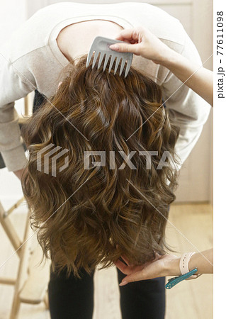 light brown long curly loose hair closeup photo in hair salon back view light brown long curly loose hair closeup photo in hair salon back view 77611098