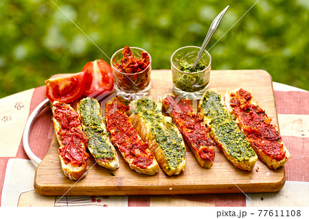 hot chili tomato and pesto sauce, sliced roasted italian ciabatta bread for cooking bruschetta sandwiches 77611108
