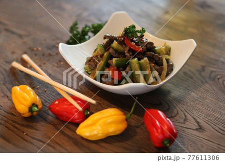 Salad with cucumbers. peppers and beef. Spicy Korean-style salad. 77611306