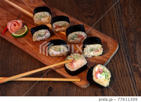 hot roll set sashimi japanese food on wooden background with lemon and chopsticks hot roll set sashimi japanese food on wooden background with lemon and chopsticks 77611309