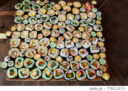 Sushi Set - Different Types of Maki Sushi and Nigiri Sushi. Served on dark wooden table. 77611321