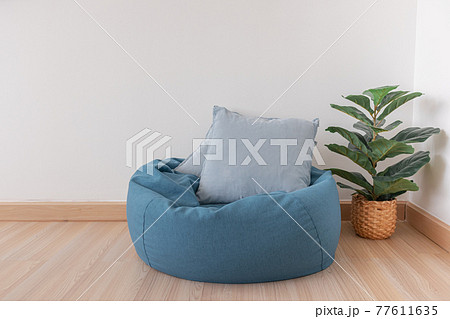 Bean bag in a clear living room with wooden floor and clear white wall. Bean bag in a clear living room with wooden floor and clear white wall. 77611635