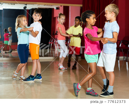 Children trying partner dance in class Children trying partner dance in class 77612373