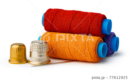 Tailor, needles and threads over white background Tailor, needles and threads over white background 77612925