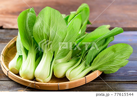 Fresh Bok Choy or Pak Choi (Chinese cabbage) in bamboo basket on wooden background 77615544