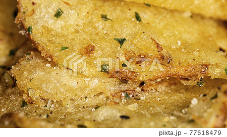 Natural fat potato chips with salt, black pepper, herbs and vegetable oil 77618479