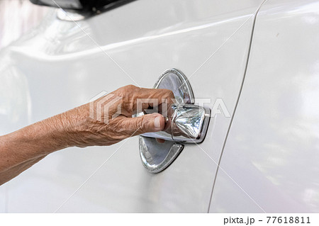 Elderly woman open car door at home elderly,senior,senior Elderly woman open car door at home elderly,senior,senior 77618811