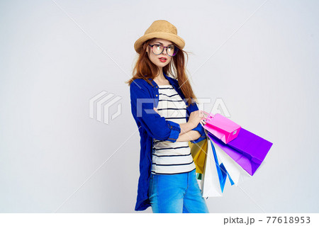 pretty woman with packages in hands n shopping consumption lifestyle blue background 77618953