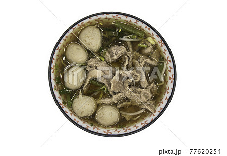 Beef clear soup with sliced beef, meatball and vegetables in bowl isolated on white background with clipping path. 77620254