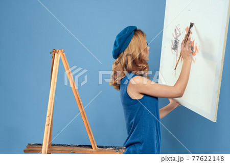 Woman artist tail hand brush drawing art Creative lifestyle blue background Woman artist tail hand brush drawing art Creative lifestyle blue background 77622148