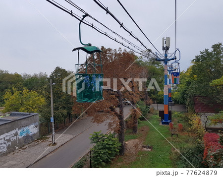 View of a famous cable car in Odessa with the sea in the background. Colored cabins. Travel background. View of a famous cable car in Odessa with the sea in the background. Colored cabins. Travel background. 77624879