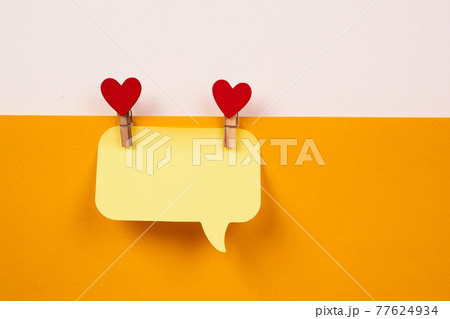a note on a yellow piece of paper and a wooden clothespin with a heart Creativity Copy Space a note on a yellow piece of paper and a wooden clothespin with a heart Creativity Copy Space 77624934