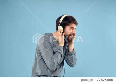 man wearing headphones music emotion lifestyle modern style technology blue background man wearing headphones music emotion lifestyle modern style technology blue background 77625000