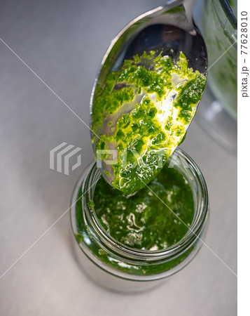 Fresh home made wild garlic pesto. Close up view of pesto sauce 77628010
