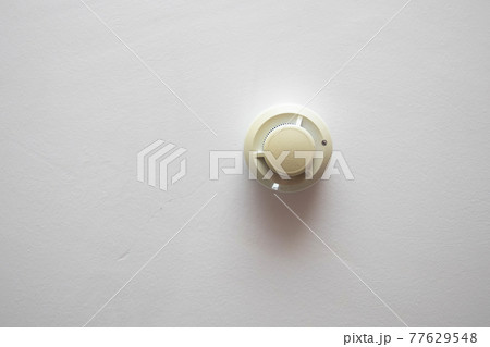 Smoke detector on the ceiling. Alarm security system hanging on ceiling Smoke detector on the ceiling. Alarm security system hanging on ceiling 77629548
