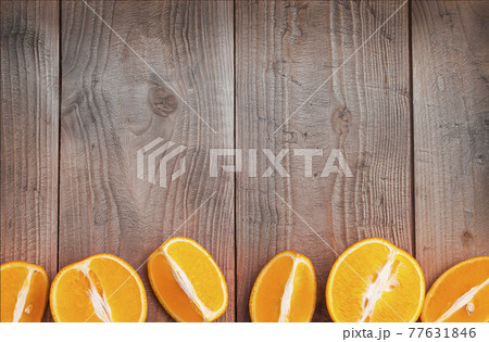 Organic orange fruit. Slices on wooden background. Selective focus Organic orange fruit. Slices on wooden background. Selective focus 77631846